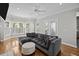 Inviting living room features plush seating, bay windows, and doors that allow for seamless indoor-outdoor living at 11 Harleston Pl, Charleston, SC 29401