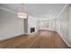 Spacious living room with wood floors features a fireplace, bay windows, and tasteful interior design elements at 11 Harleston Pl, Charleston, SC 29401