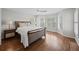 Bedroom with hardwood floors, neutral walls, bay window, and comfortable upholstered bed at 11 Harleston Pl, Charleston, SC 29401