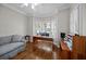Bright office with hardwood floors, white shutters, crown molding, and comfortable seating at 11 Harleston Pl, Charleston, SC 29401