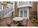 Lovely outdoor patio space with string lights, a brick privacy wall, and a patio table with four chairs at 11 Harleston Pl, Charleston, SC 29401