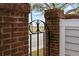 View of the waterfront through a brick and iron fence at 11 Harleston Pl, Charleston, SC 29401