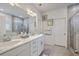 Bright bathroom featuring a double vanity with marble countertop and a glass enclosed shower at 110 Angelica Ave, Summerville, SC 29483