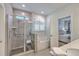 Elegant bathroom featuring a glass-enclosed shower, soaking tub, and neutral tile at 110 Angelica Ave, Summerville, SC 29483