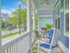 Inviting front porch features rocking chairs with blue cushions and a view of the neighborhood at 110 Angelica Ave, Summerville, SC 29483