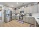 Modern kitchen with stainless steel appliances, gray cabinets, and plenty of counter space at 110 Angelica Ave, Summerville, SC 29483
