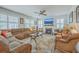 Inviting living room boasts a comfortable sectional sofa, fireplace, ceiling fan, and lots of natural light at 110 Angelica Ave, Summerville, SC 29483