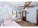 Bright bedroom with hardwood floors, sheer curtains, and a white ceiling fan at 110 Wallace Rd, Goose Creek, SC 29445