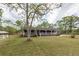 Charming brick home features a long, covered front porch and a well-manicured lawn at 110 Wallace Rd, Goose Creek, SC 29445