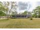 Charming brick home features a long, covered front porch and a well-manicured lawn at 110 Wallace Rd, Goose Creek, SC 29445