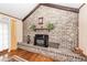 Close-up view of brick fireplace with raised hearth and rustic wood accents in the living room at 110 Wallace Rd, Goose Creek, SC 29445