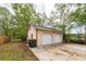 A detached two-car garage with white doors and a side entrance is an ideal space for cars and storage at 110 Wallace Rd, Goose Creek, SC 29445