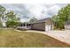 Brick home's three-car garage, a covered front porch, and a lush lawn enhance this home's curb appeal at 110 Wallace Rd, Goose Creek, SC 29445