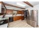 Bright kitchen boasting stainless steel appliances, wood cabinets, and hardwood flooring at 110 Wallace Rd, Goose Creek, SC 29445