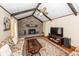 Inviting living room with vaulted ceilings, brick fireplace, ceiling fan, and beautiful area rug at 110 Wallace Rd, Goose Creek, SC 29445