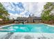 An in-ground pool with the home in the background, offering a backyard oasis for relaxation and entertainment at 110 Wallace Rd, Goose Creek, SC 29445
