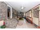 Bright sunroom with brick walls and tile flooring offers a cozy seating area at 110 Wallace Rd, Goose Creek, SC 29445