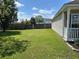 Expansive backyard showcasing a lush green lawn and partial view of the home's exterior at 1119 Moss Grove Dr, Moncks Corner, SC 29461