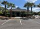 Attractive community clubhouse and swimming pool lined with palm trees at 1119 Moss Grove Dr, Moncks Corner, SC 29461