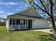 Inviting one-story home featuring a charming front porch and two car garage at 1119 Moss Grove Dr, Moncks Corner, SC 29461