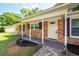 Inviting front porch with brick columns and decorative flower bed at 115 White Blvd, Summerville, SC 29483