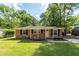 Charming brick home featuring a well-maintained lawn and beautiful landscaping at 115 White Blvd, Summerville, SC 29483