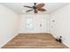 Bright living room with new flooring, window, ceiling fan and exterior door at 115 White Blvd, Summerville, SC 29483