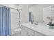 Clean bathroom featuring a shower-tub combo with blue curtain and a bright vanity with a large mirror at 116 Slater Lake Ln, Summerville, SC 29483
