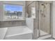 Bathroom featuring glass shower stall, soaking tub, and views of the community at 116 Slater Lake Ln, Summerville, SC 29483