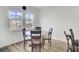 Bright breakfast nook with a round table, four chairs, and natural light from two windows overlooking the yard at 116 Slater Lake Ln, Summerville, SC 29483