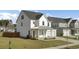 Stylish two-story home featuring modern architecture, a well-manicured lawn, and attached garage at 116 Slater Lake Ln, Summerville, SC 29483