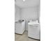 Bright laundry room featuring a modern washer and dryer, with shelving for added storage at 116 Slater Lake Ln, Summerville, SC 29483