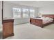 Spacious bedroom with a large bed, dresser, and three windows offering natural light and neighborhood views at 116 Slater Lake Ln, Summerville, SC 29483