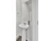 Compact powder room features a pedestal sink, decorative mirror, and modern fixtures in a neutral color palette at 116 Slater Lake Ln, Summerville, SC 29483