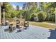 Backyard featuring a spacious deck, lush greenery, and mature trees, perfect for outdoor entertaining and relaxation at 116 Trestlewood Dr, Summerville, SC 29486