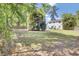 Backyard featuring a spacious lawn, exterior elevation of the home, deck and mature trees at 116 Trestlewood Dr, Summerville, SC 29486