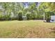 Backyard featuring a spacious lawn, gazebo, and mature trees, perfect for outdoor entertaining and relaxation at 116 Trestlewood Dr, Summerville, SC 29486
