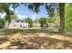 Spacious backyard with a well-maintained lawn, patio area, and mature trees offering shade and privacy at 116 Trestlewood Dr, Summerville, SC 29486