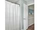 Bathroom with a white shower curtain, an open doorway, and neutral-colored walls at 116 Trestlewood Dr, Summerville, SC 29486