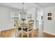 Bright dining area features wood floors, an elegant chandelier, and access to the kitchen, creating a welcoming atmosphere at 116 Trestlewood Dr, Summerville, SC 29486