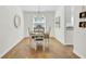 Dining area with wood floors, a modern chandelier, and a large window offers a cozy and inviting space at 116 Trestlewood Dr, Summerville, SC 29486
