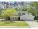 Inviting two-story home with a lovely front porch, attached garage, and lush green lawn at 116 Trestlewood Dr, Summerville, SC 29486