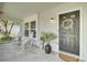 Inviting front porch featuring rocking chairs, a decorative wreath, and a welcoming ambiance at 116 Trestlewood Dr, Summerville, SC 29486