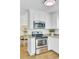 Well-appointed kitchen with stainless steel appliances and white cabinets, adjoins a dining area for seamless entertaining at 116 Trestlewood Dr, Summerville, SC 29486