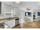 Modern kitchen with stainless steel appliances overlooks a dining area, extending to outdoor deck via sliding doors at 116 Trestlewood Dr, Summerville, SC 29486