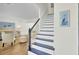 Elegant staircase with a modern design, leading to a bright and airy living area at 116 Trestlewood Dr, Summerville, SC 29486
