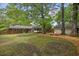 Expansive backyard features a detached garage and patio with mature trees, ideal for relaxation at 1211 Eastwood Ave, Hanahan, SC 29410