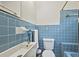 Compact bathroom featuring blue tiled walls, a modern sink, and toilet with coordinated blue fixtures at 1211 Eastwood Ave, Hanahan, SC 29410