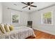 Bedroom with hardwood floors, a queen size bed, a ceiling fan, and natural light from the two windows at 1211 Eastwood Ave, Hanahan, SC 29410
