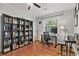 A bedroom with a bookshelf, natural light, and hardwood floors at 1211 Eastwood Ave, Hanahan, SC 29410